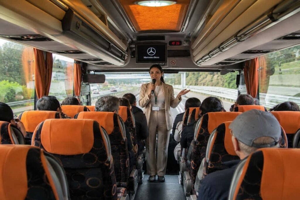 Professional tour guide speaking to passengers inside a Mercedes bus in Azerbaijan
